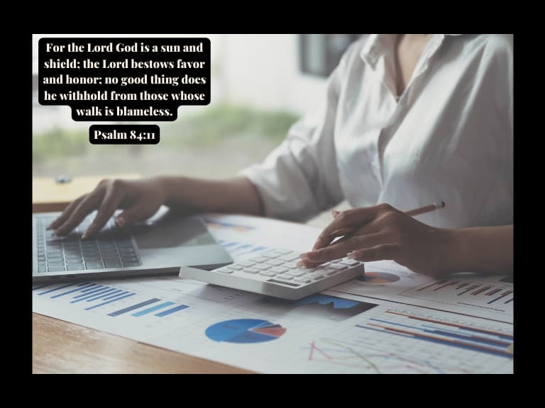 A woman reading reading bible verses about money management on her pc surrounded by graphs and infographics