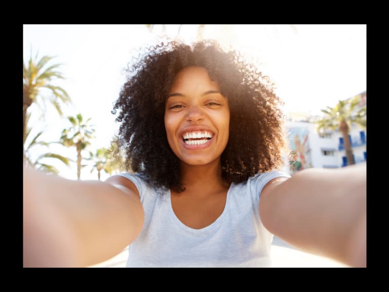 solo female traveler smiling and enjoying pictures she's taking 