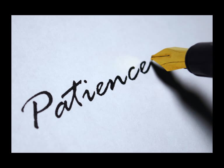 a close-up of a pen writing on a piece of paper the word patience for bible verses about patience in hard times